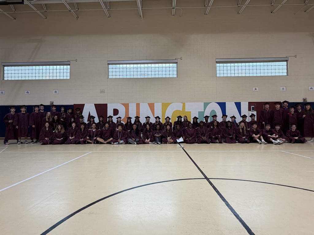 Students at Roslyn take a group photo in their caps and gowns