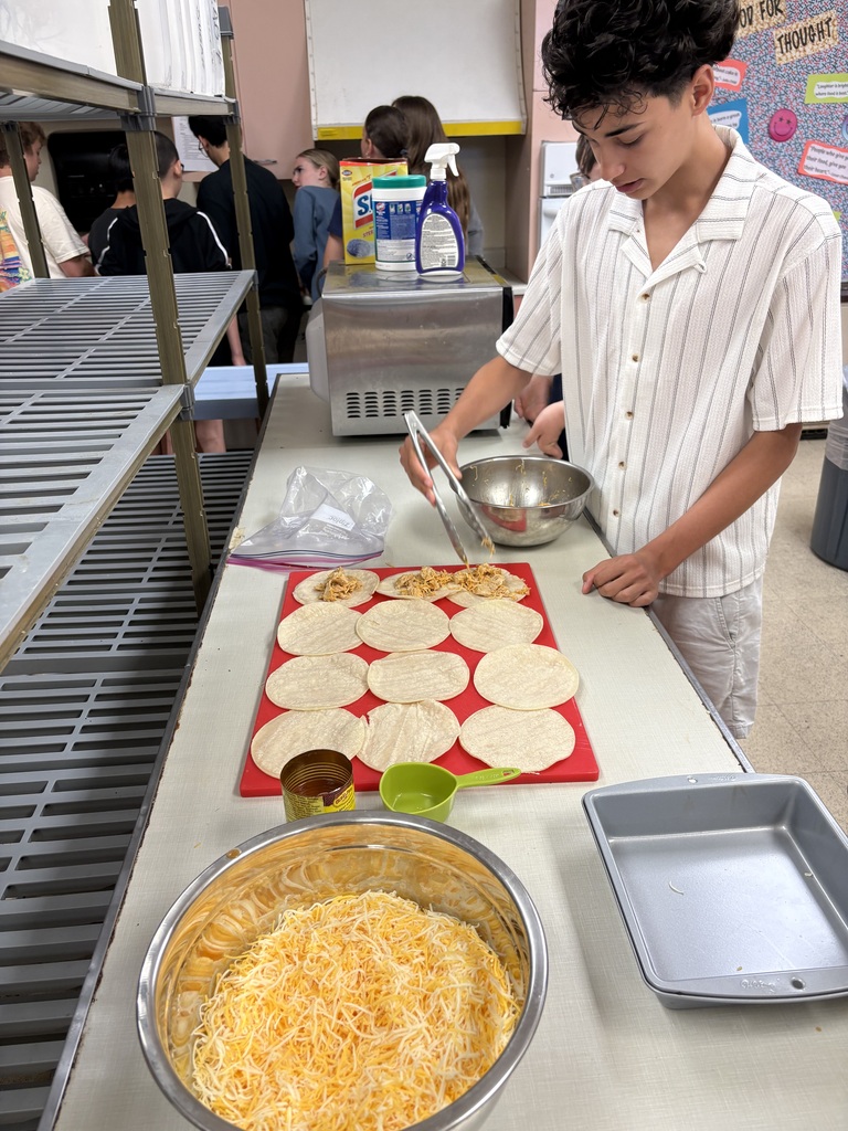 Image of students making Cheesy Chicken Enchiladas