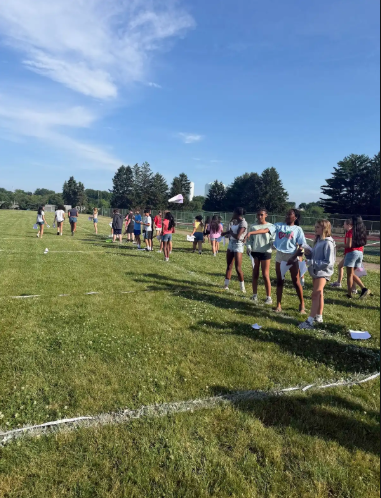 Image of 6th grade math students testing their paper airplanes