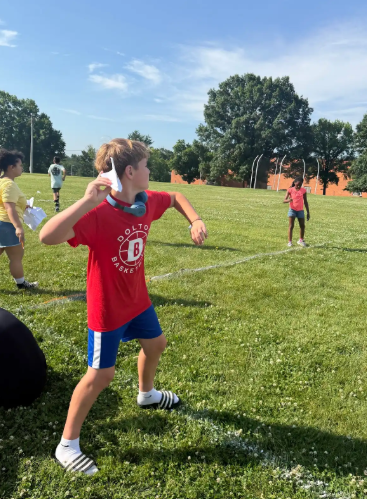 Image of 6th grade math students testing their paper airplanes