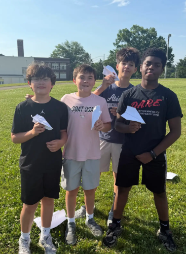 Image of 6th grade math students testing their paper airplanes