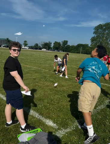 Image of 6th grade math students testing their paper airplanes