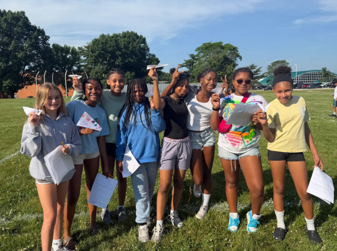 Image of 6th grade math students testing their paper airplanes