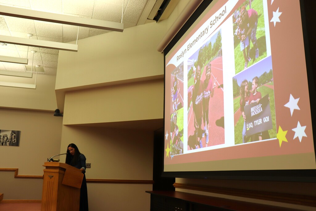 Ms. Capitolo presents at the podium during the Board meeting