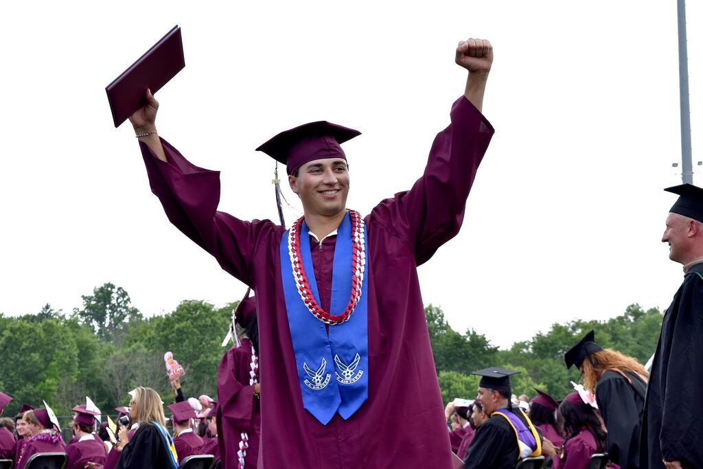 Student celebrates receiving his diploma