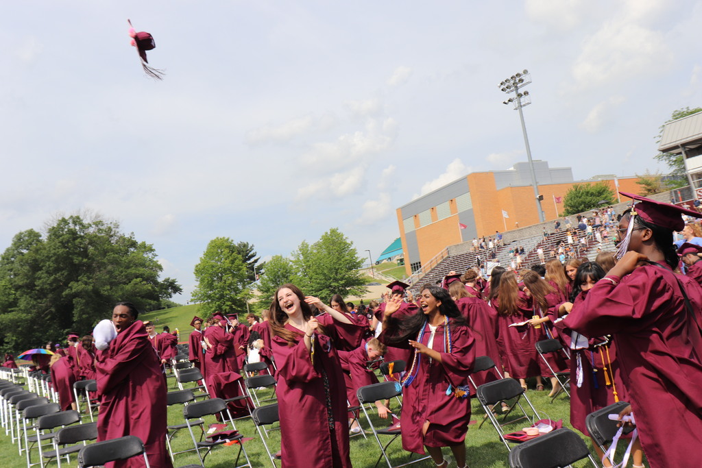 Graduates toss their caps and celebrate