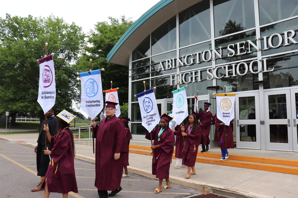 Start of the Commencement Procession with students holding Pathways banners