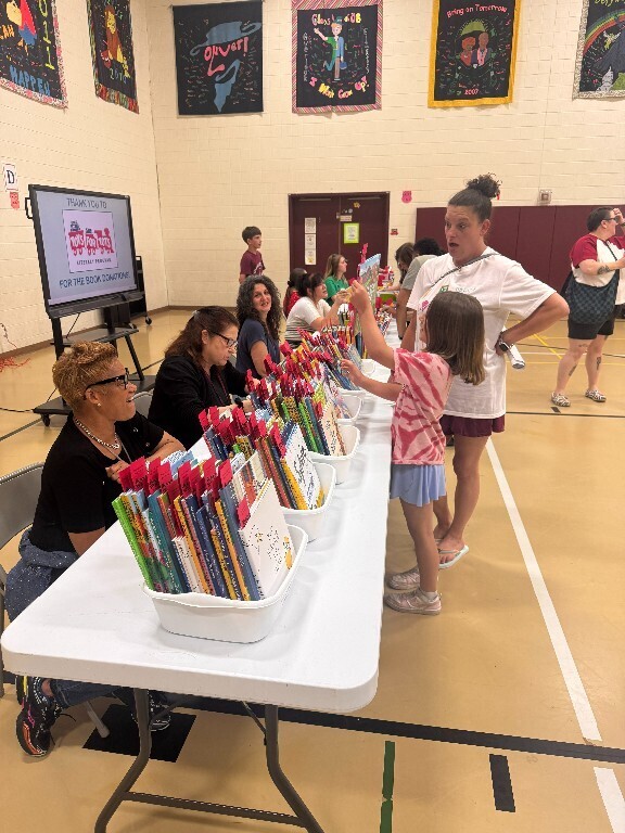 An Overlook student and family look at books available at the resource fair.