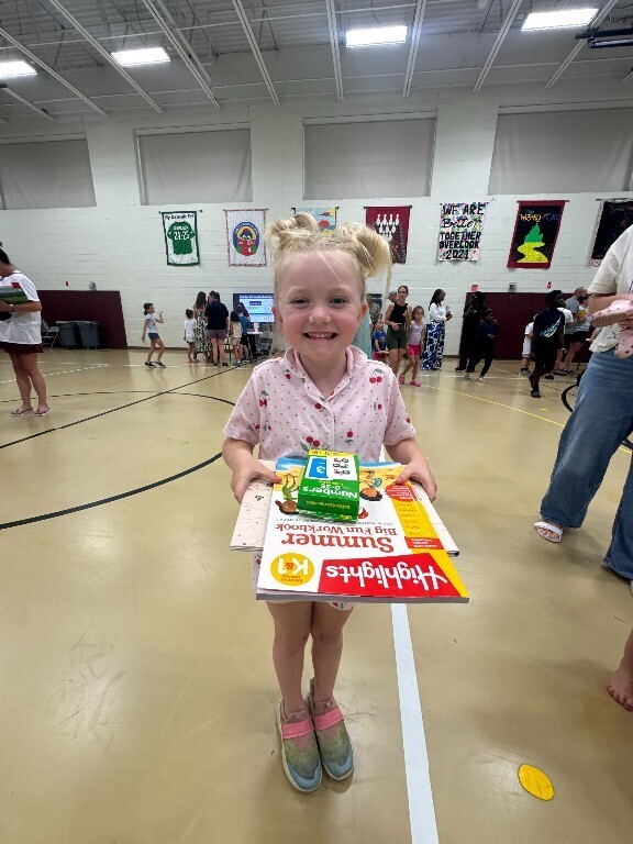 An Overlook student smiles as she carries the free resources that were provided at the fair.
