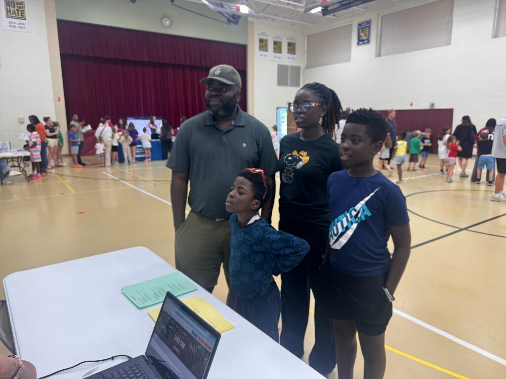 An Overlook family listens to information regarding summer resources.