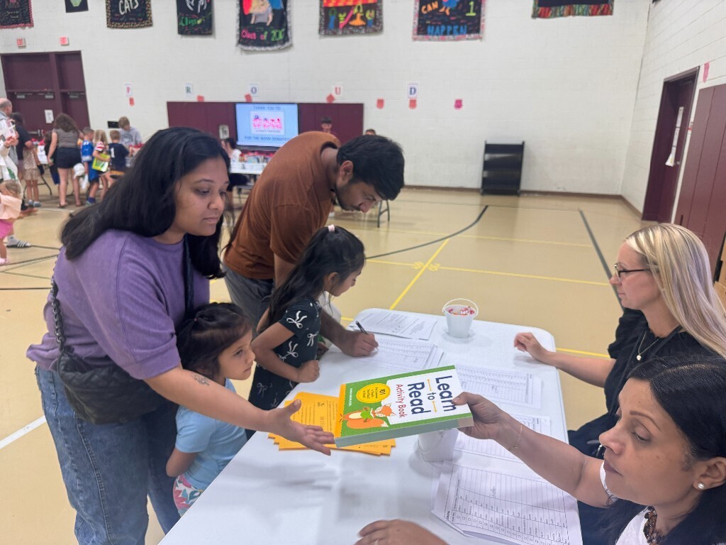 Teachers provide information and resources to an Overlook family.