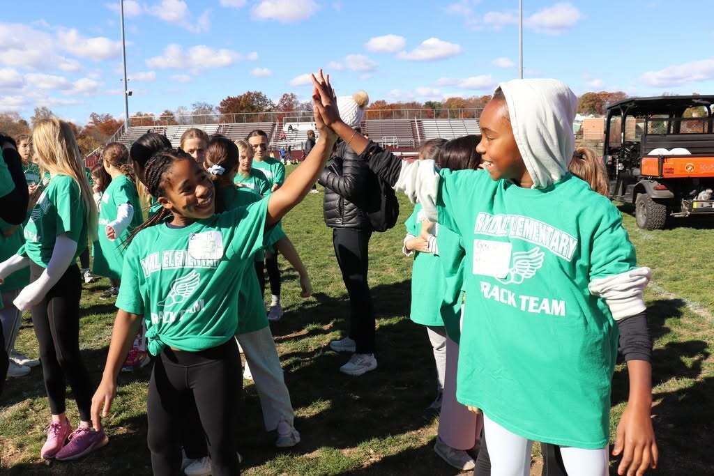 Students high-five in Rydal T-shirts at the Track Meet