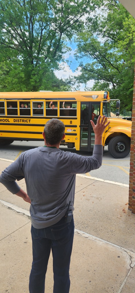Mr. Oldham waving goodbye to a bus