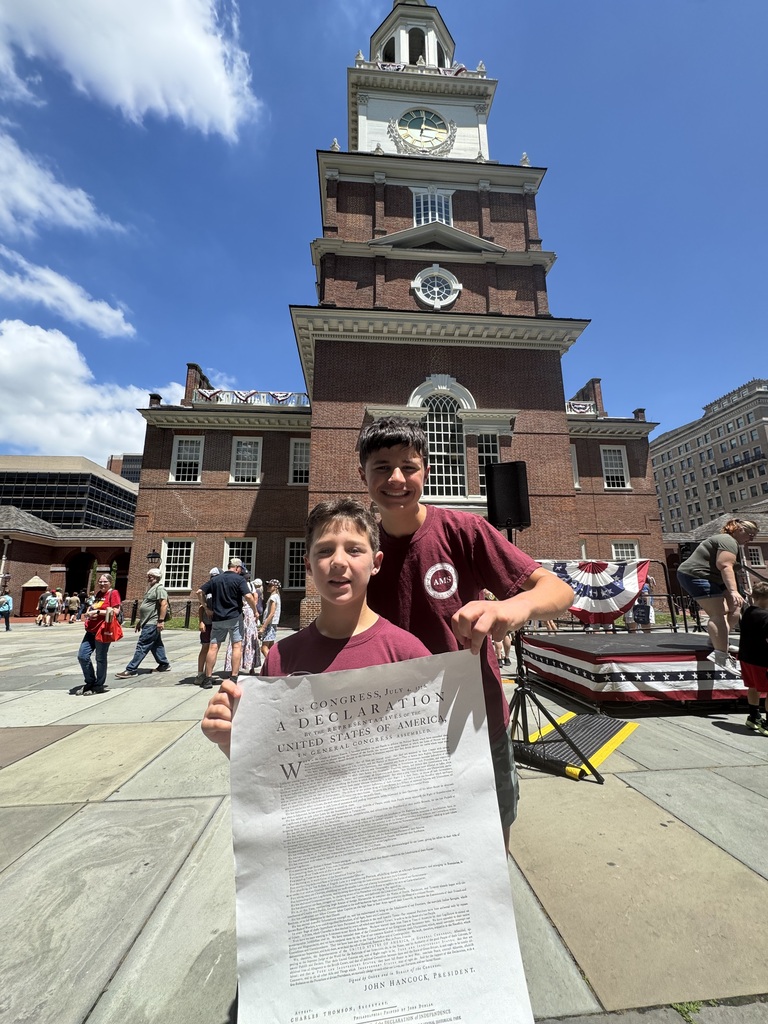 Ben & Eli hold up a copy of the Declaration on Independence at Independence Mall in Philadelphia
