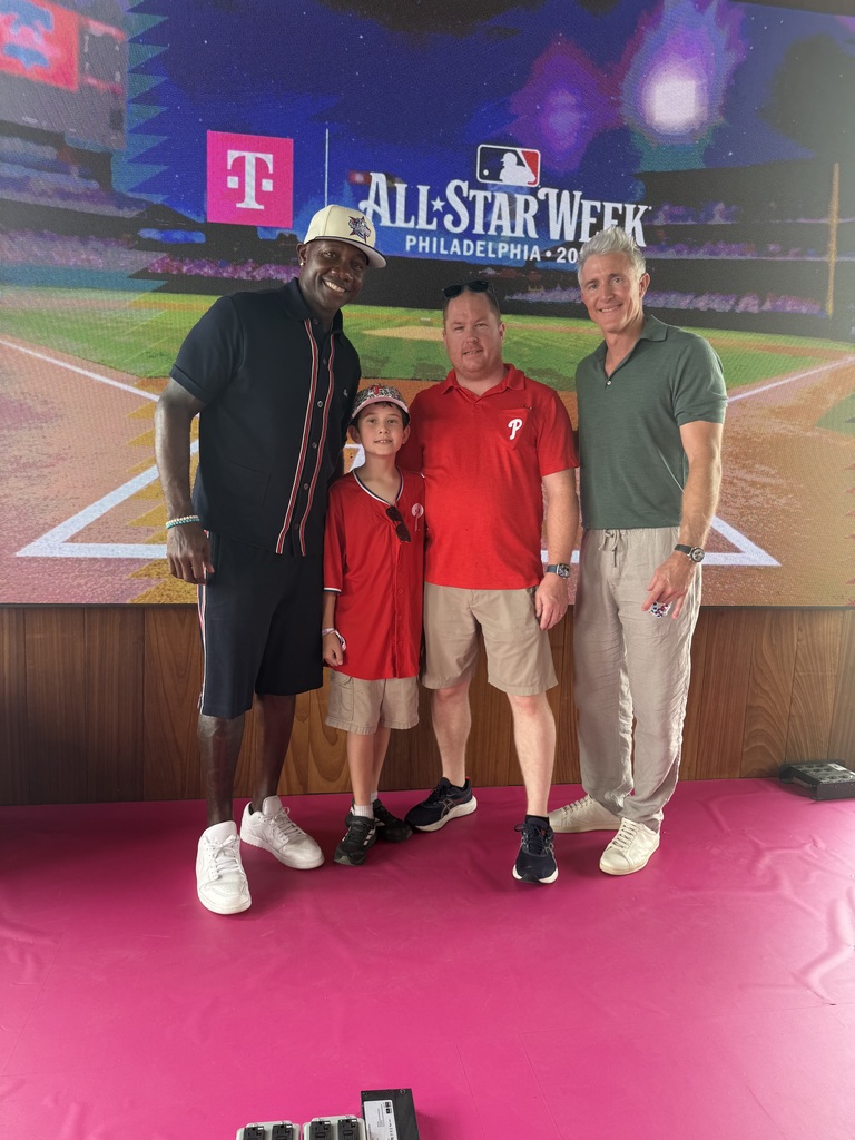 Daniel and his dads pose with baseball legends Ryan Howard & Chase Utley