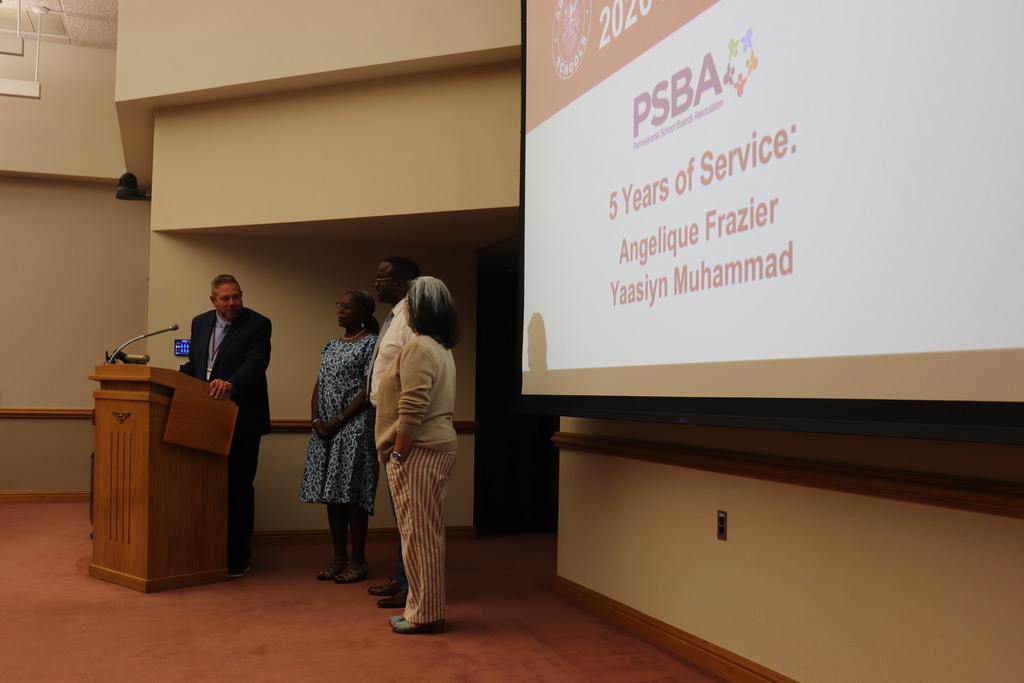 Dr. Fecher and Dr. Mowry recognize Ms. Frazier and Mr. Muhammad at the Board meeting