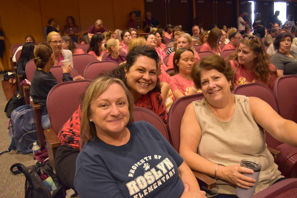 Staff catch up in the auditorium before convocation