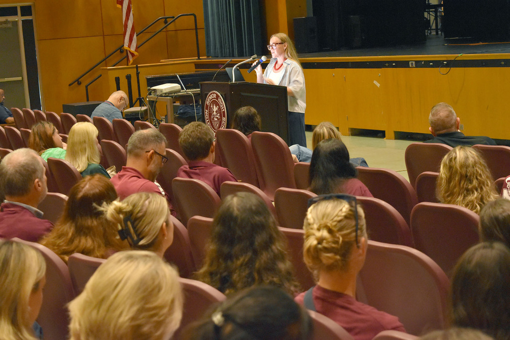 Katie Jameson presents to staff in the auditorium