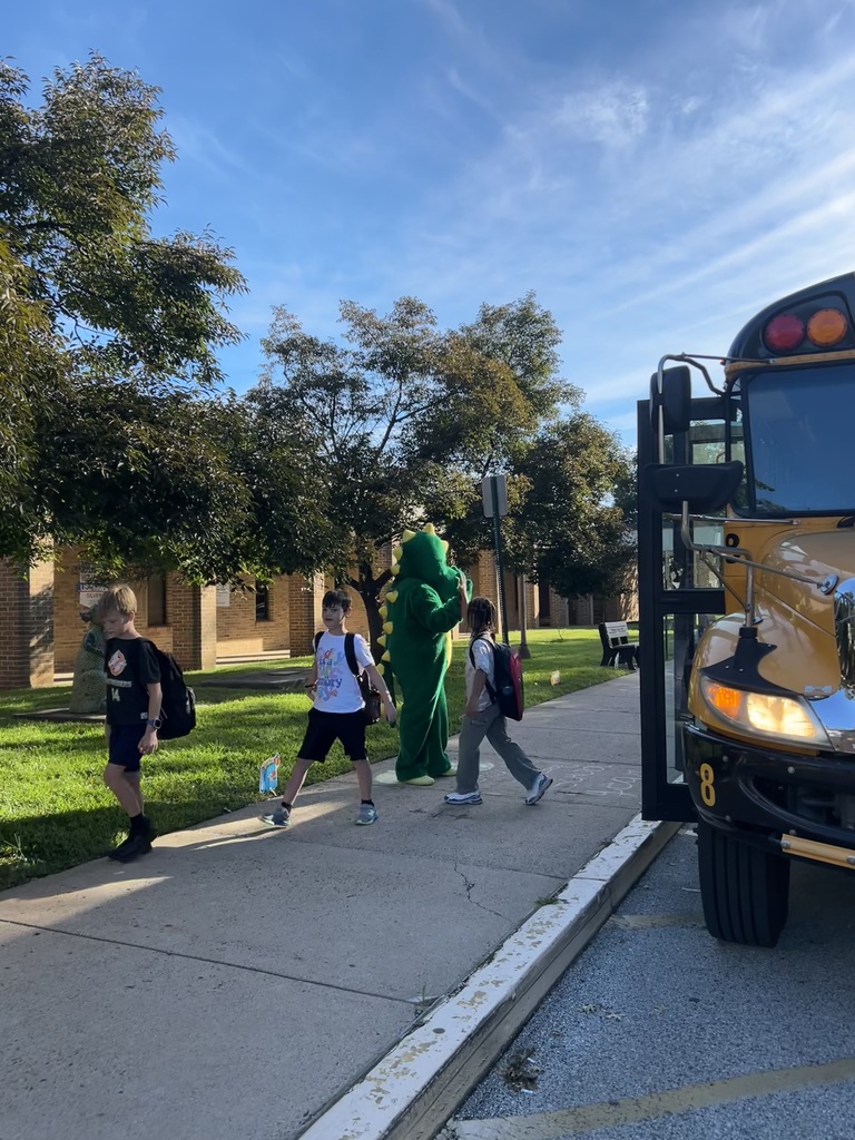 Students getting off the bus at McKinley are greeted by the Dragon mascot