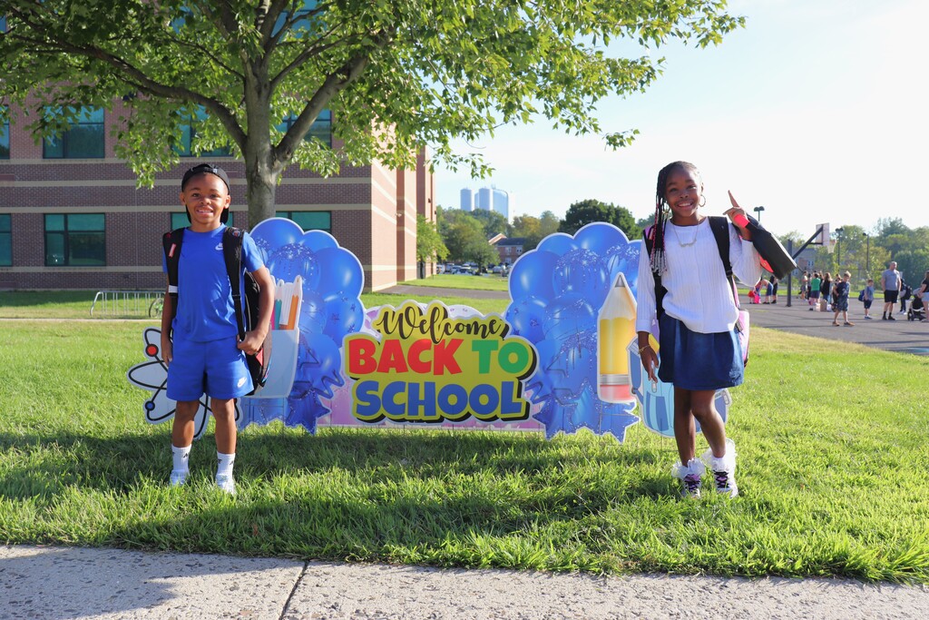 Students with Back to School sign
