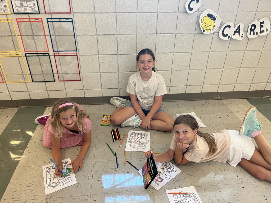 Fifth and Second Graders smiling
