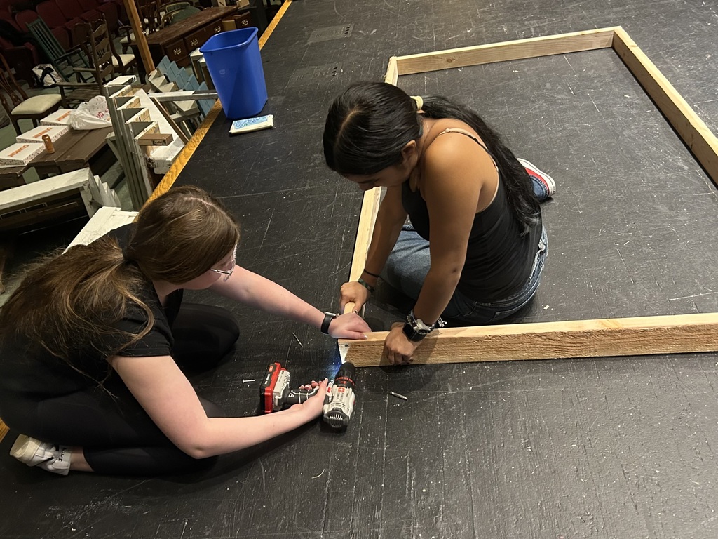 Students in the Crew build sets on stage for the fall play
