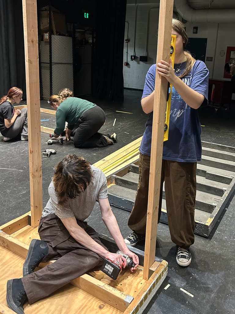 Students in the Crew build sets on stage for the fall play