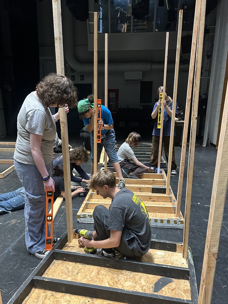 Students in the Crew build sets on stage for the fall play