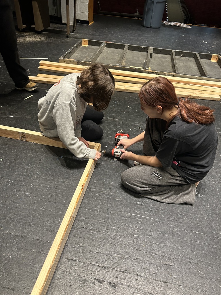 Students in the Crew build sets on stage for the fall play