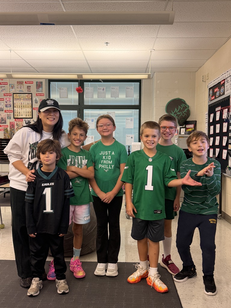 Mrs. Chung and her students smiling in Eagles gear
