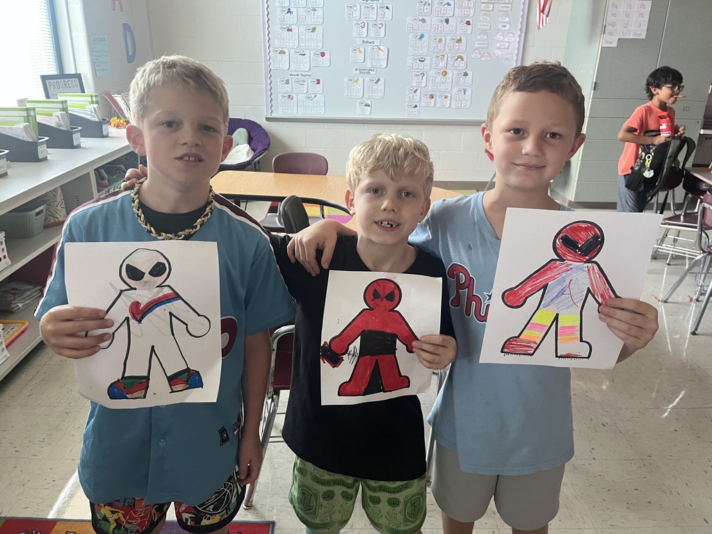 students smiling with their projects