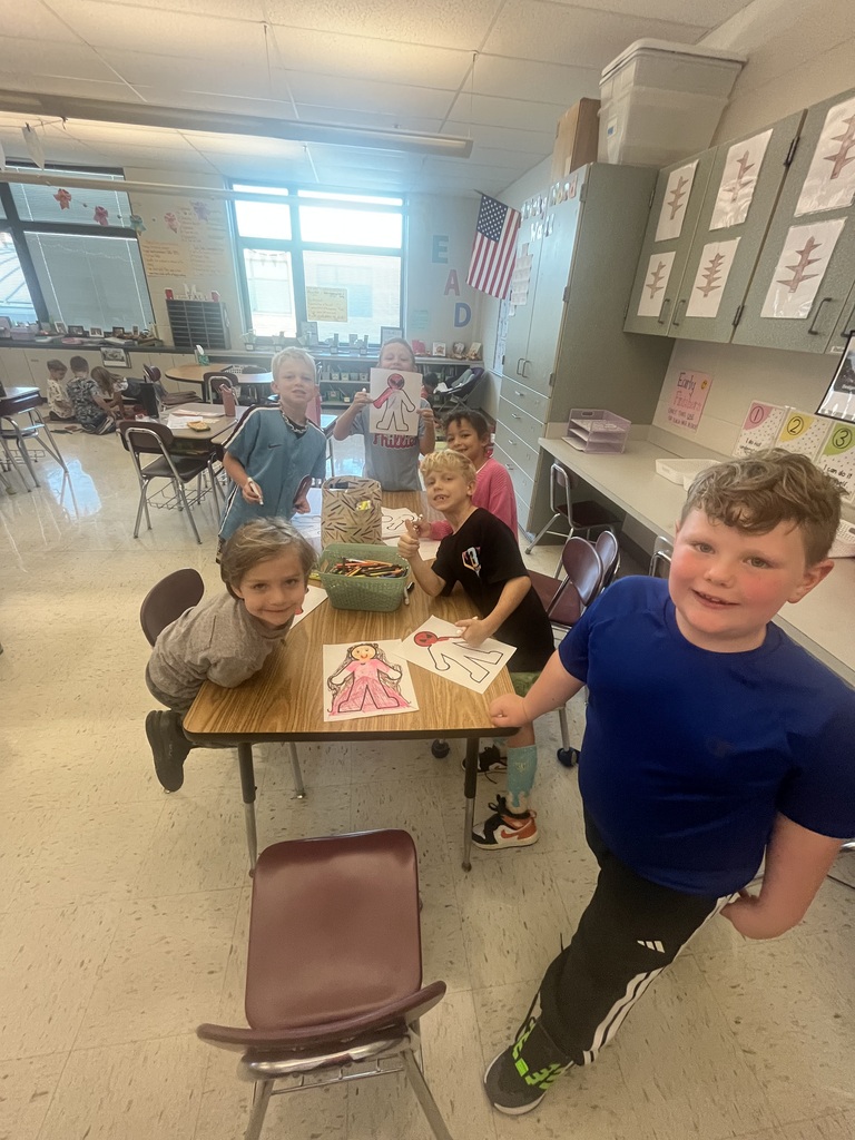 students smiling with their projects