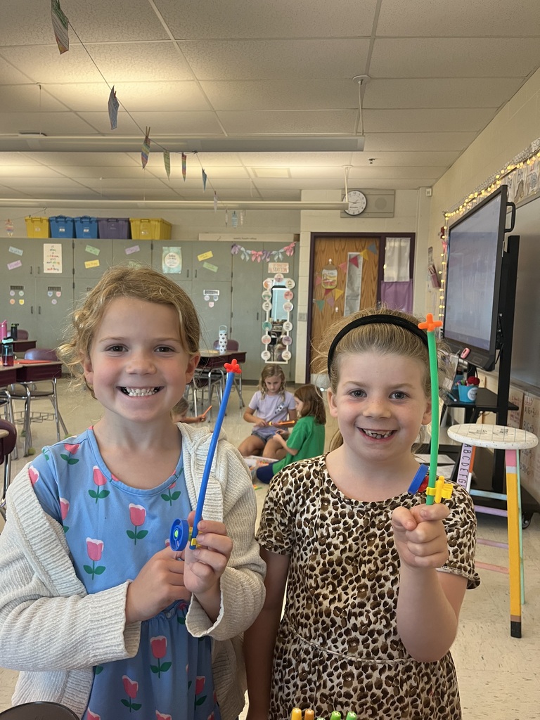 students smiling with their projects