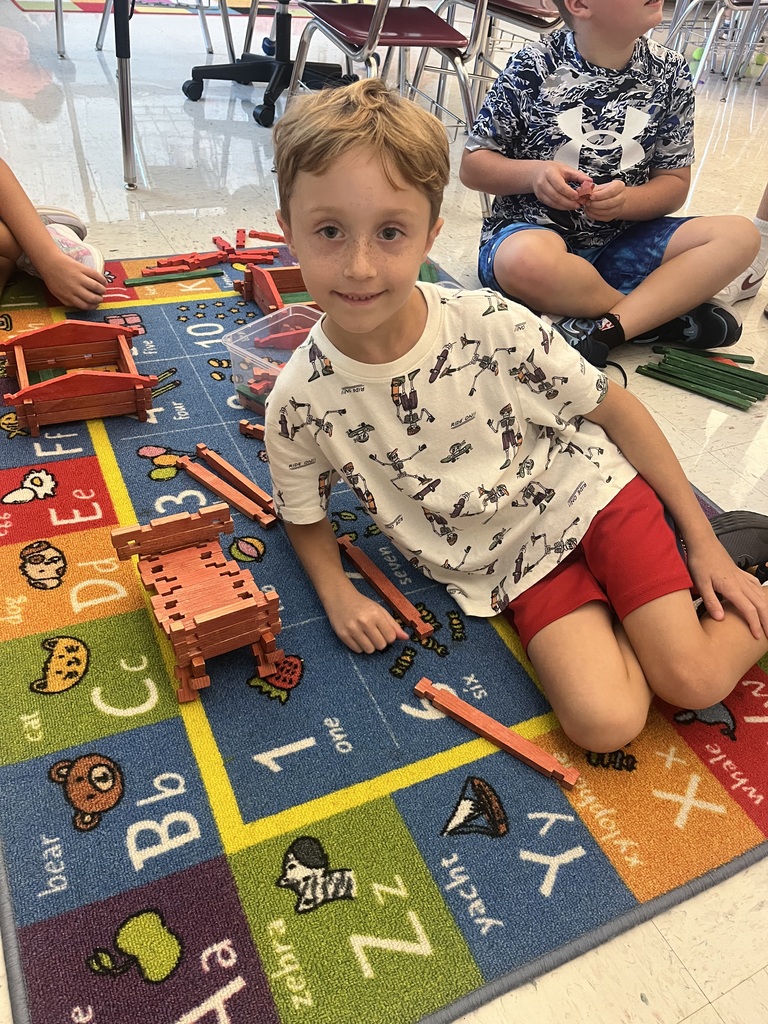 students smiling with their projects
