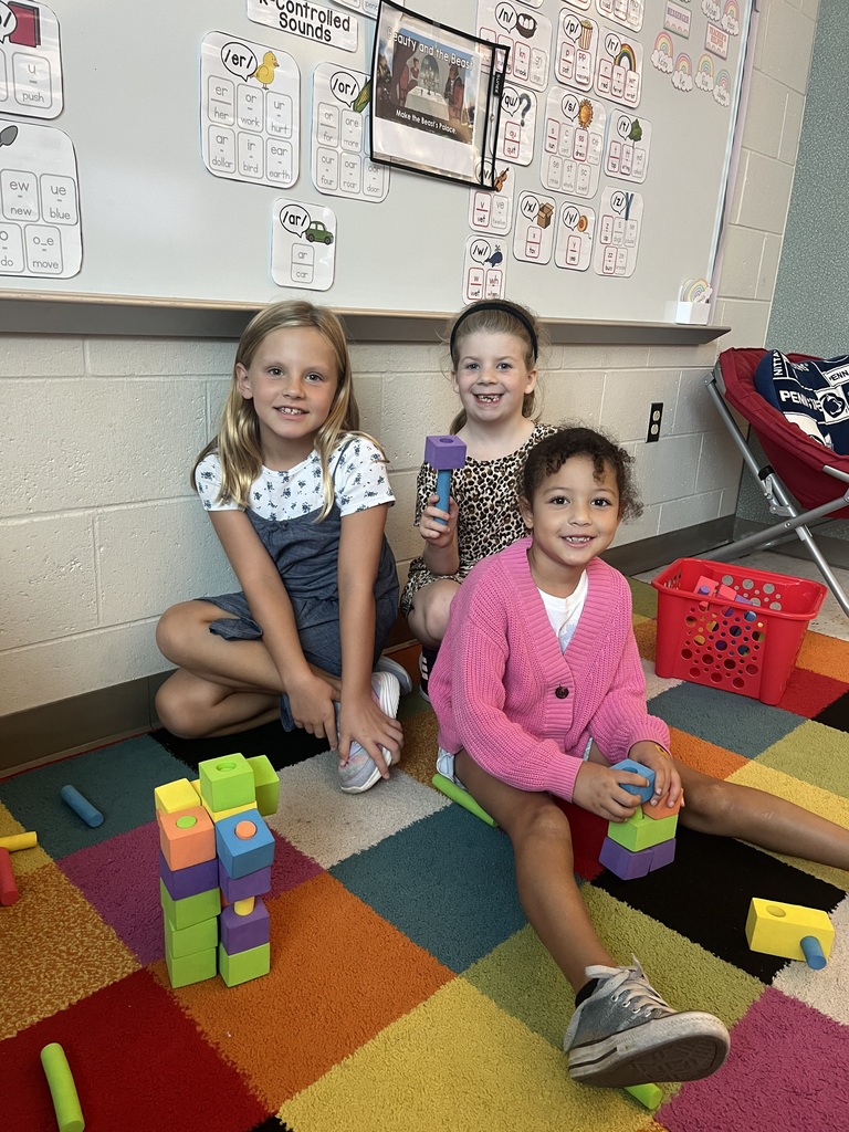 students smiling with their projects