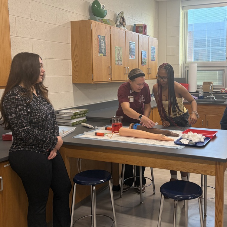 teacher helping student  