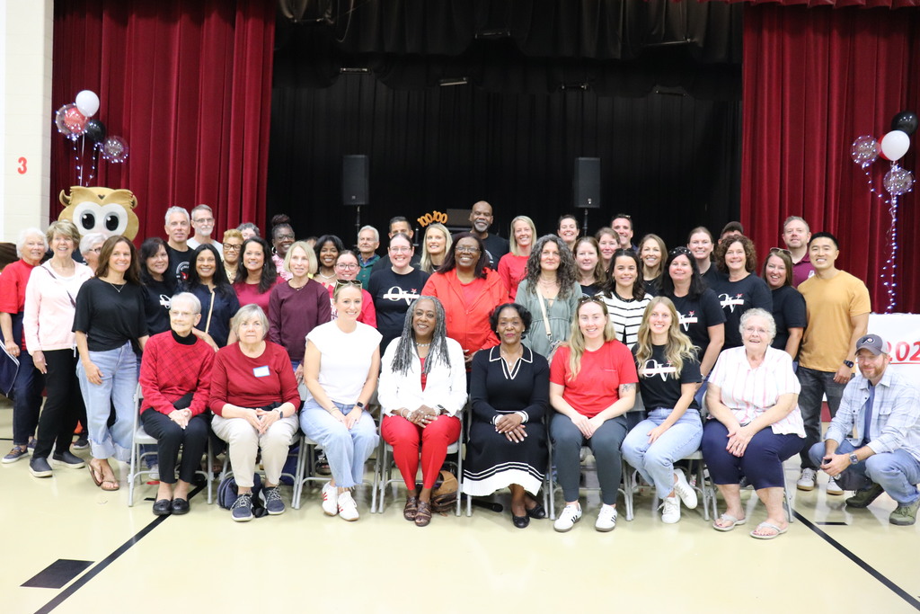 Current and past staff gather for a photo