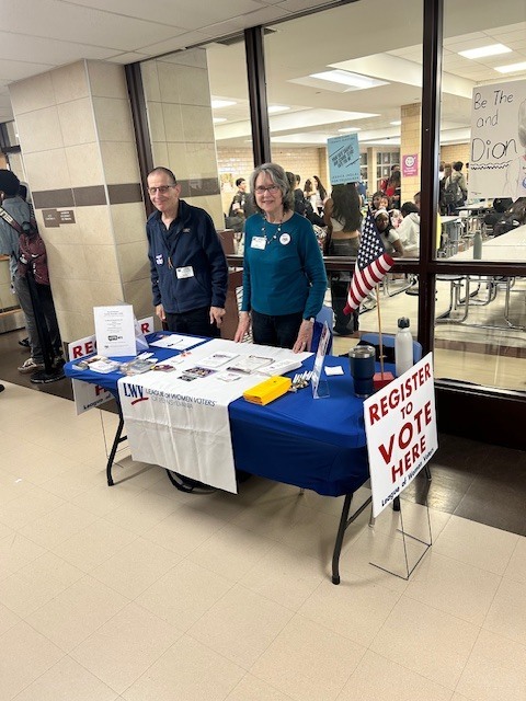 Volunteers station an Information Table outside of the cafeteria