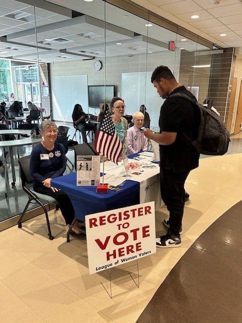 Volunteers provide information to a student