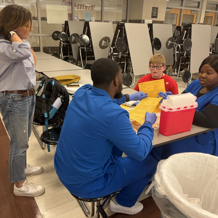 A student and parent speaks with nurses