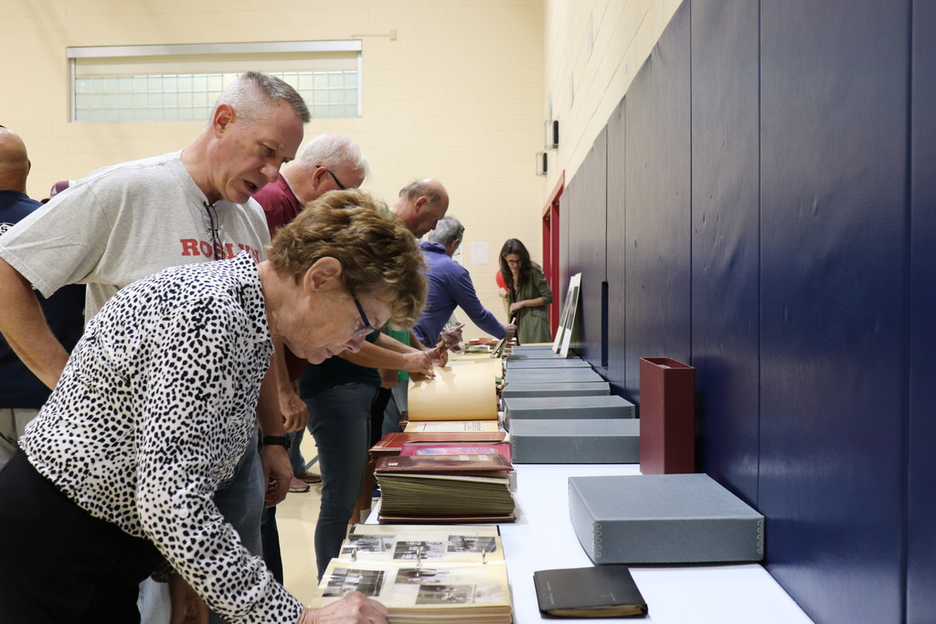 Attendees look through old photo albums