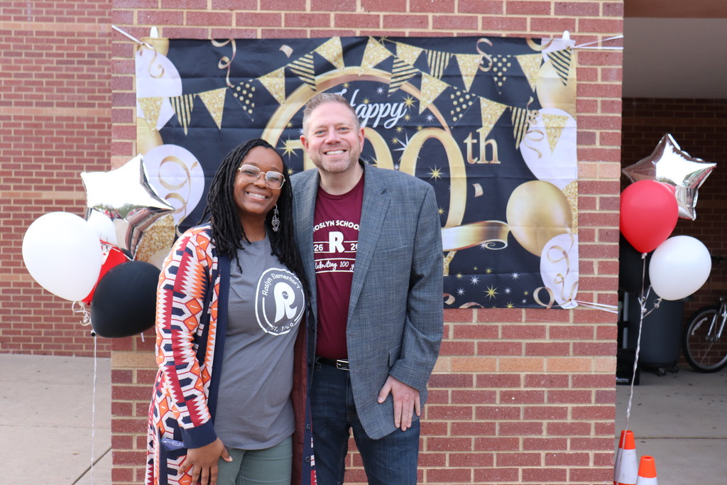 Shameeka Browne and Dr. Fecher in front of a celebratory banner
