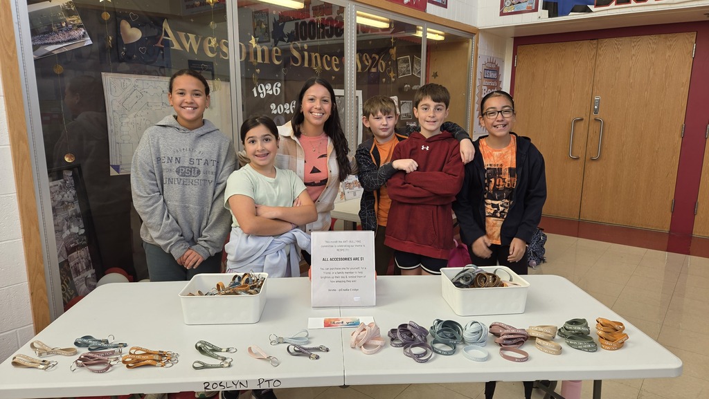 Rolyn Elementary students stand in front of a table of items promoting kindness and unity 