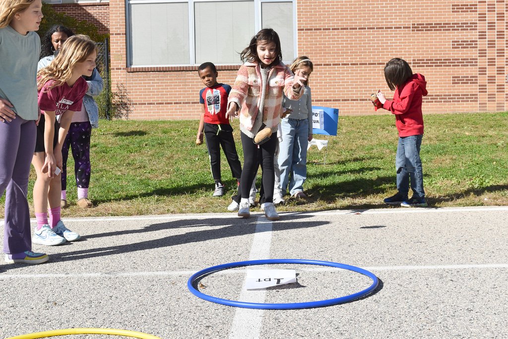 A second grader tosses her potato athlete in a test of skill and accuracy