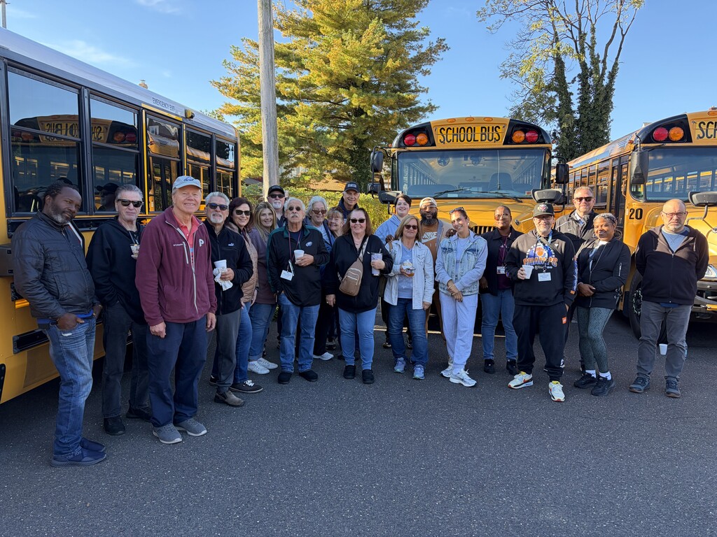 Transportation Department staff in front of buses