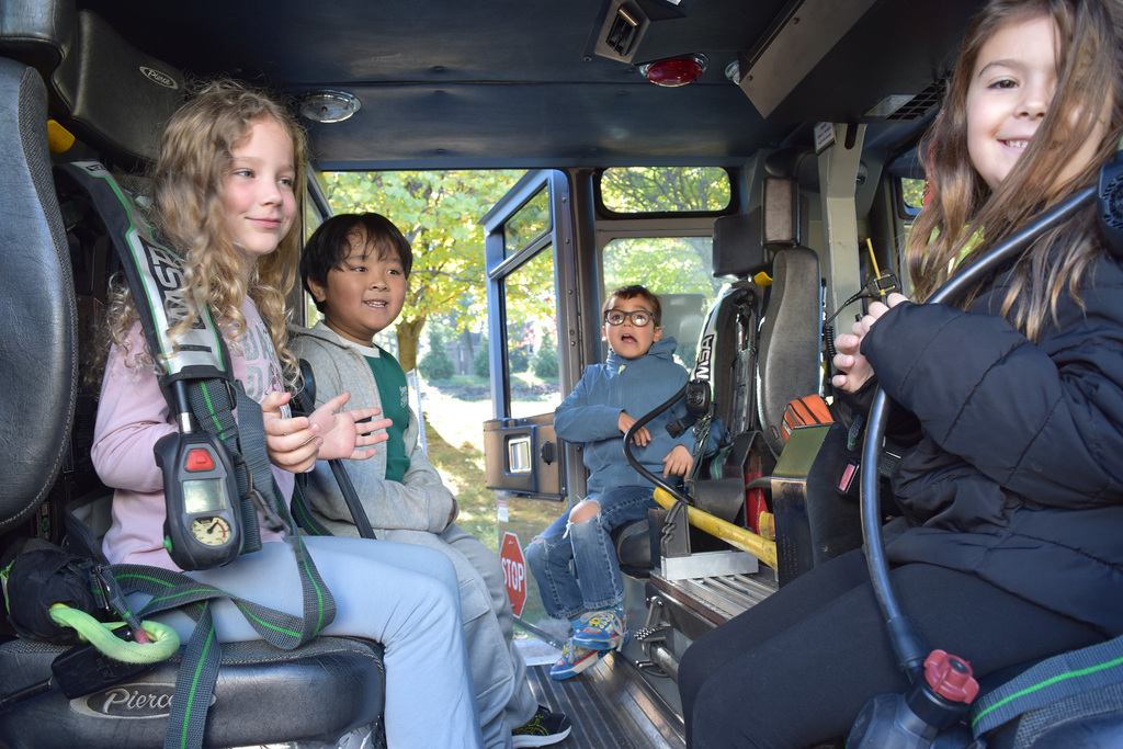 Students take a turn at sitting in the firetruck