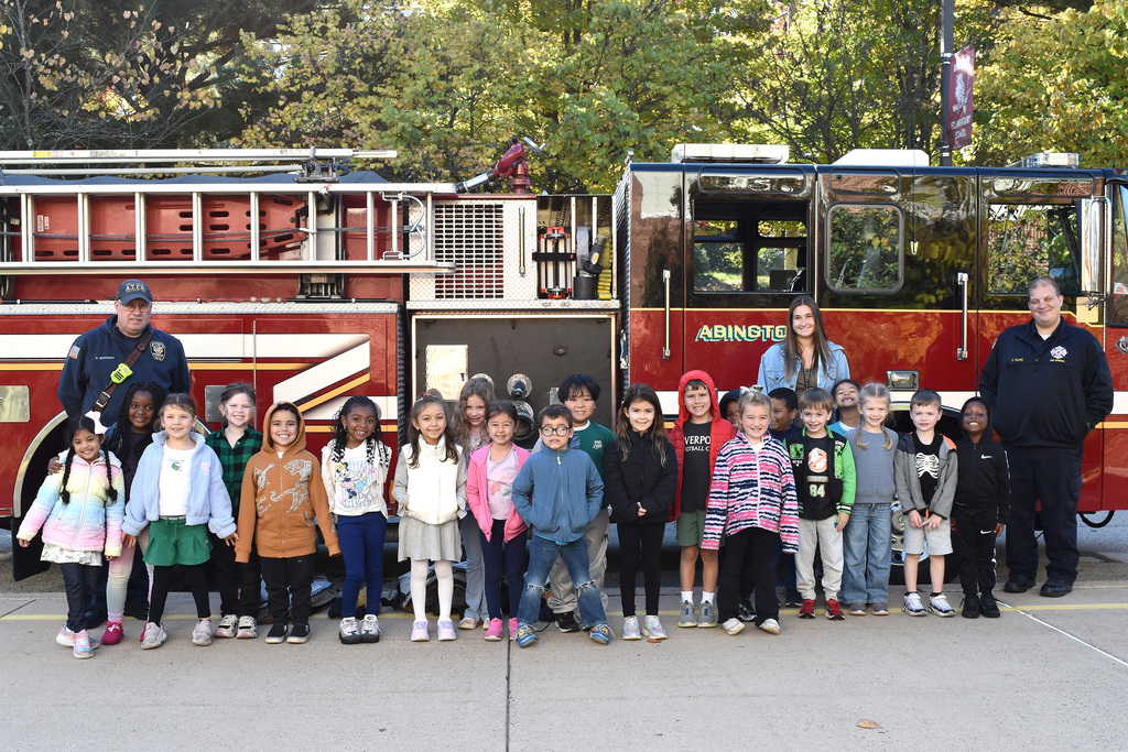 Overlook kindergarten class poses in front of the Abington Fire Company firetruck with firefighters