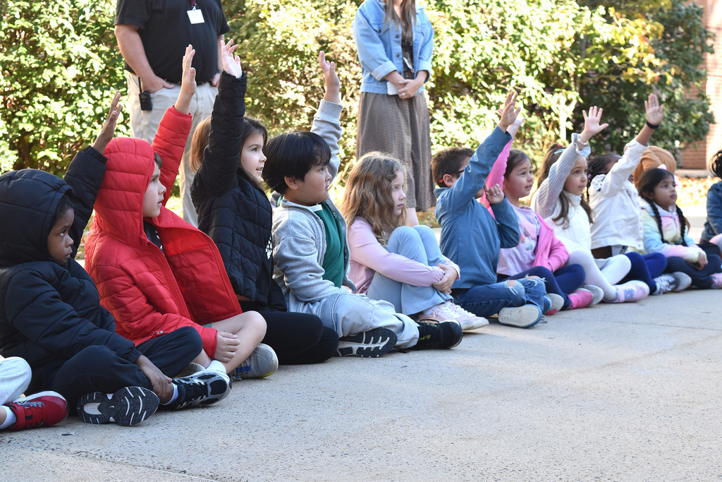 Overlook kindergarteners paise their hands to respond to Abington firefighters' questions