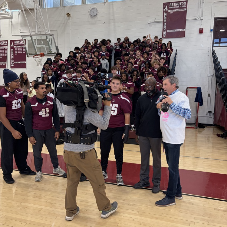 Bob Kelly interviews the football team for a live segment