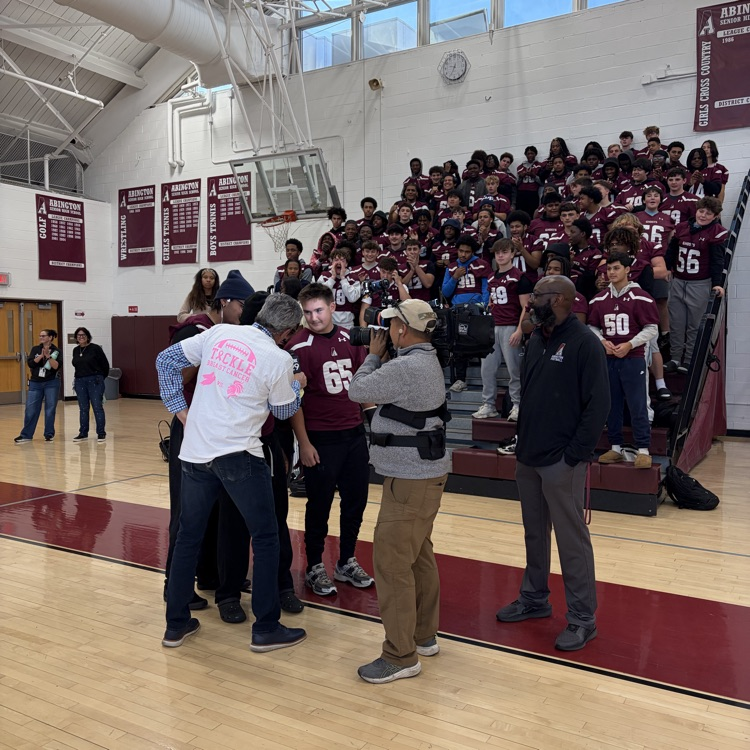 Bob Kelly interviews the football team for a live segment